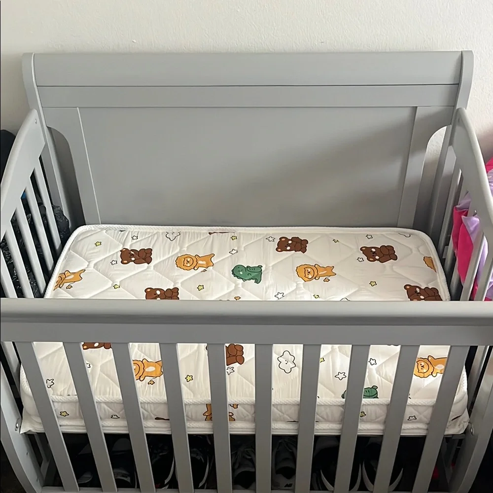 Gray Baby Crib with Printed Mattress